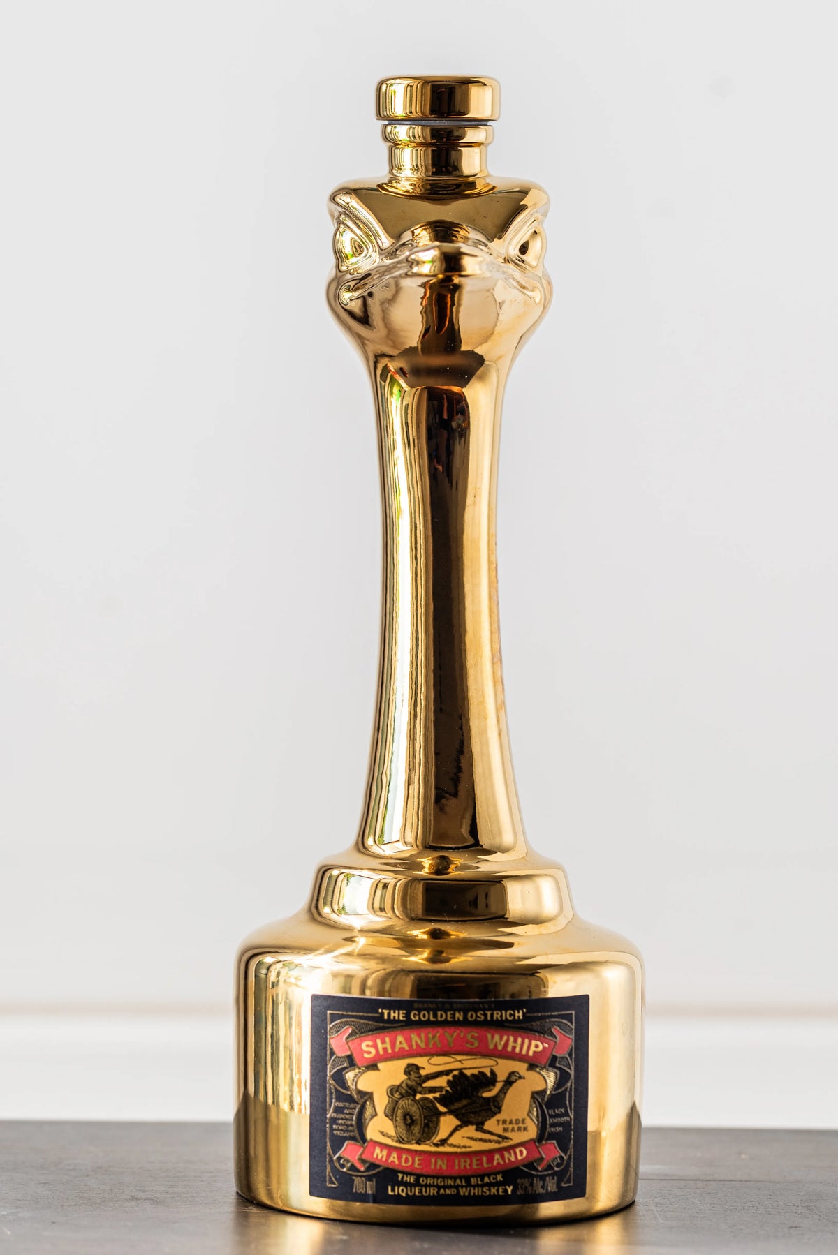 Shanky's Whip Gold bottle and ostrich head stopper, second angled view