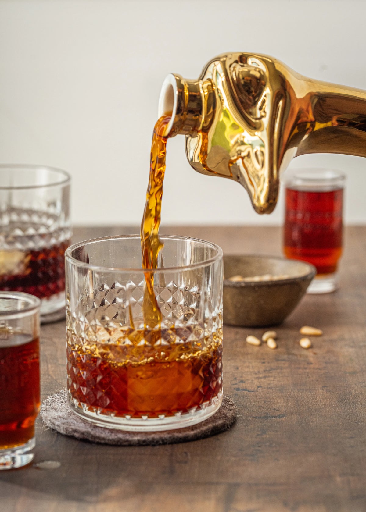 Shanky's Whip Gold liqueur pouring through the ostrich head spout