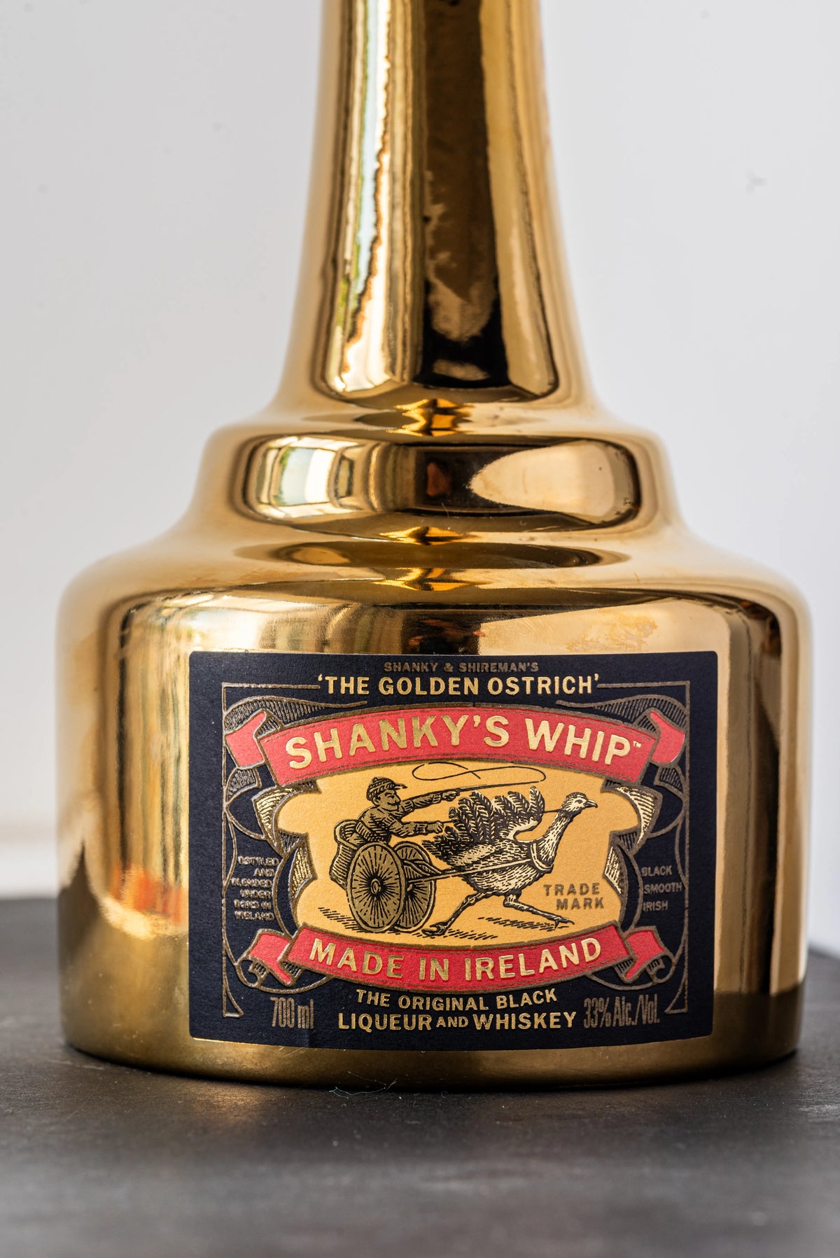 Close-up of the ostrich head stopper and label on the Shanky's Whip Gold bottle