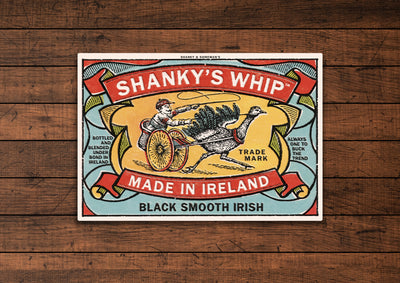 Shanky's Whip tin sign mounted on a dark wood panel